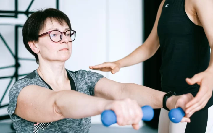 A woman performing a barbell lunge in a gym rack