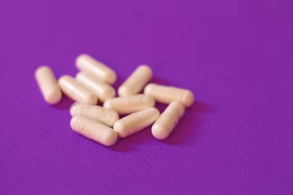 Pale capsules scattered on a purple background