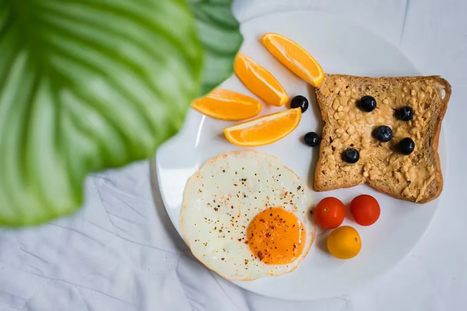 Fried eggs, wholegrain toast with blueberries and orange segments