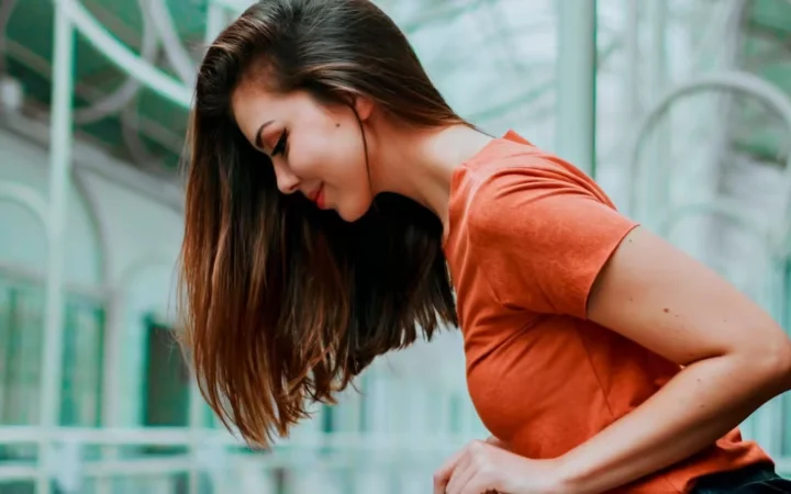 A woman in profile with long hair falling across her shoulder