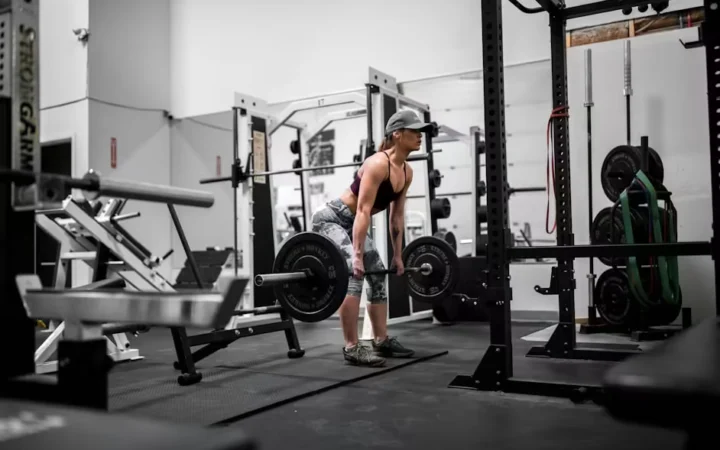 A gym floor lined with racks and benches