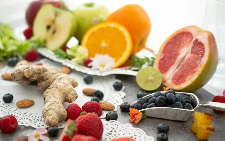 Fresh fruit, berries and ginger arranged on a table