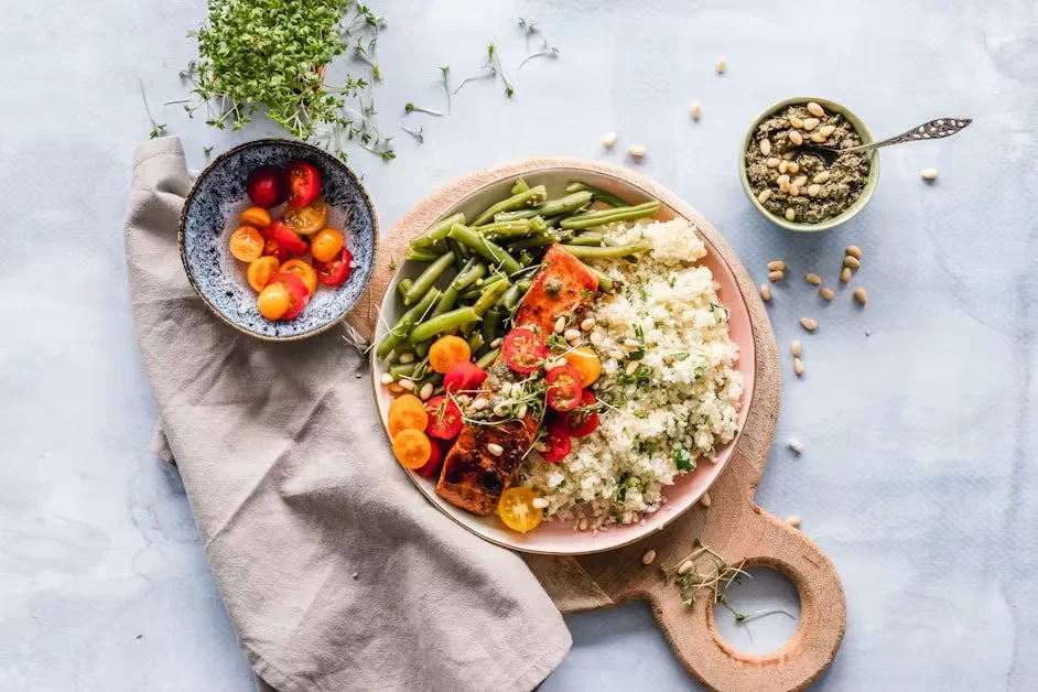 A bowl of couscous with green beans and roasted tomatoes