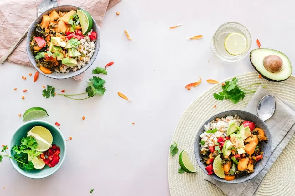 Two grain bowls with avocado, lime and coriander