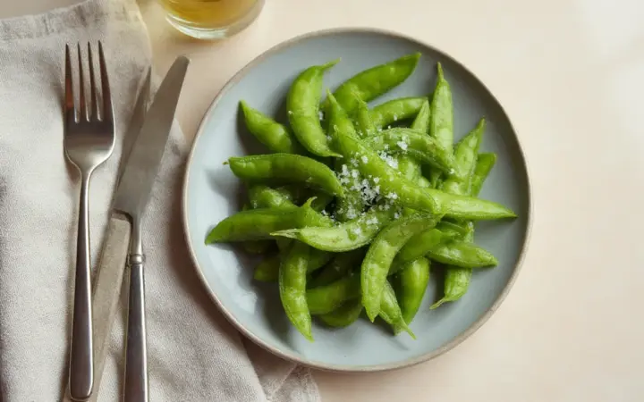 Generated illustration of edamame with sea salt, not a photograph of the dish