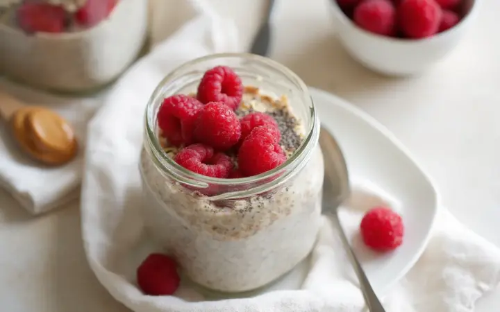 Generated illustration of overnight chia oats with raspberries, not a photograph of the dish